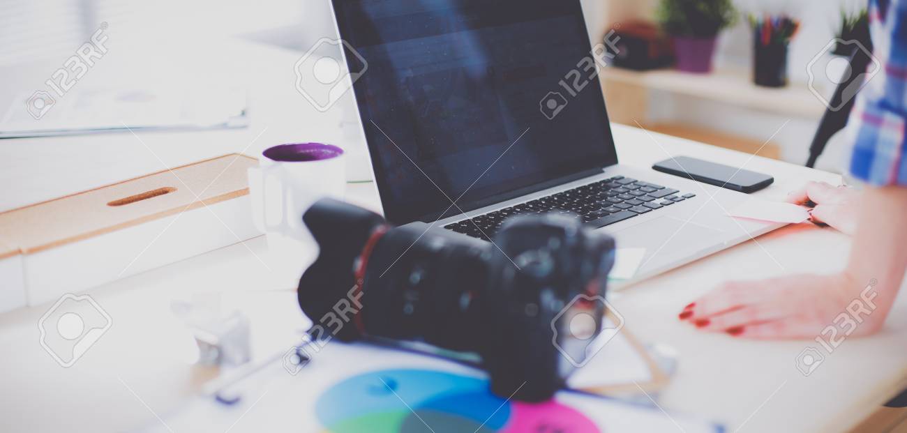 OCR A2 Media Studies 1 90148575 female photographer sitting on the desk with laptop female photographer