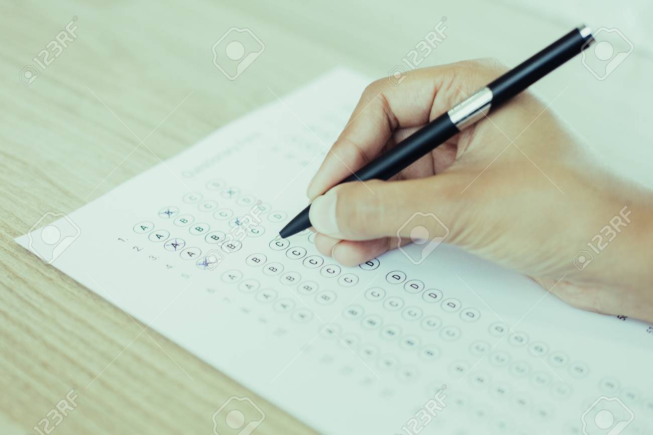 OCR A Level Timetable 1 98836759 closeup of hand holding pen and filling out questionary form on table