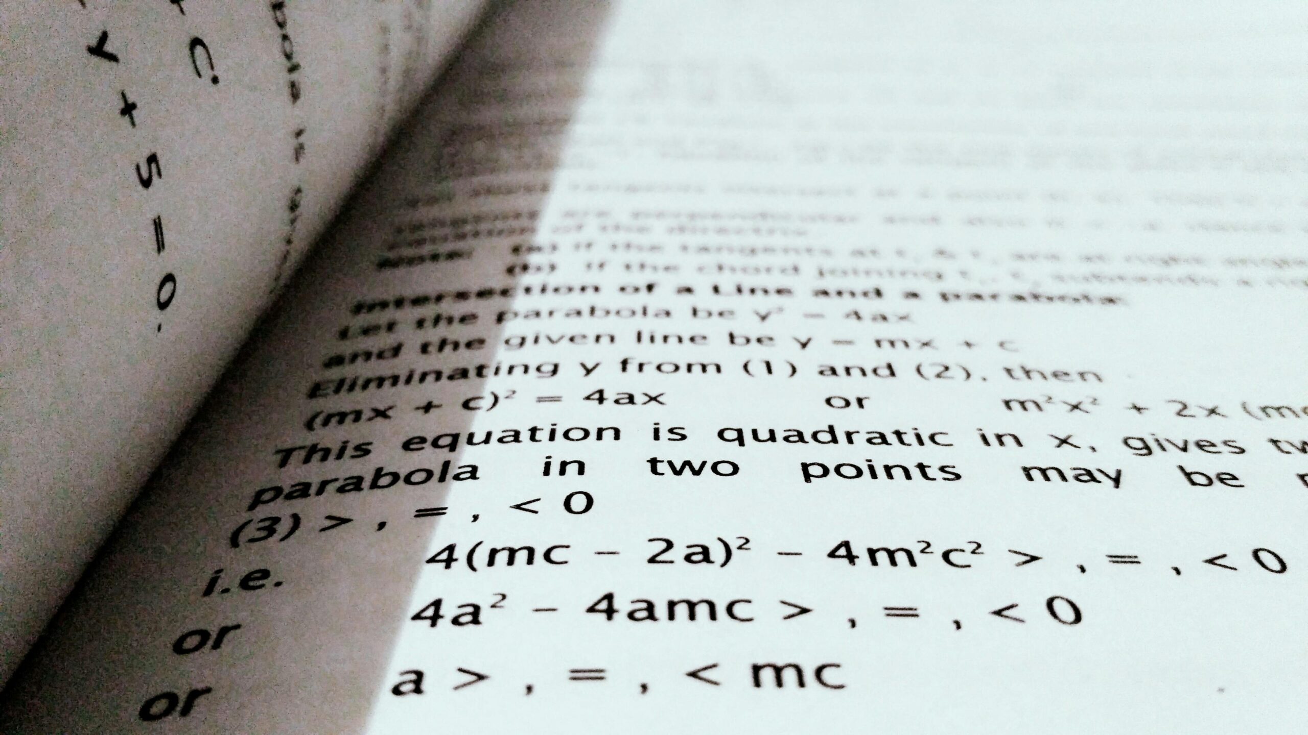 GCSE Maths Online 1 A close-up shot of mathematical equations on a book page, perfect for education and learning concepts.